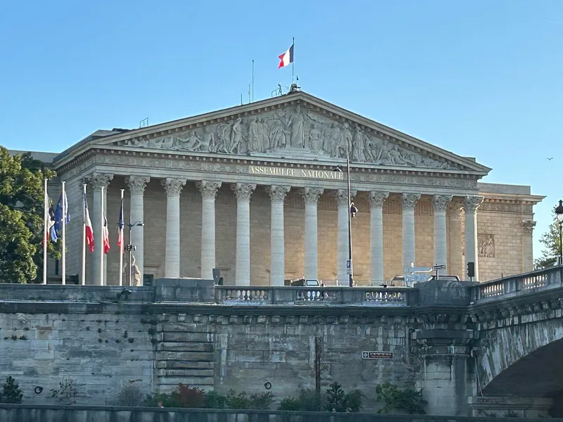 The columned facade of the Assemblee Nationale seen from the Seine