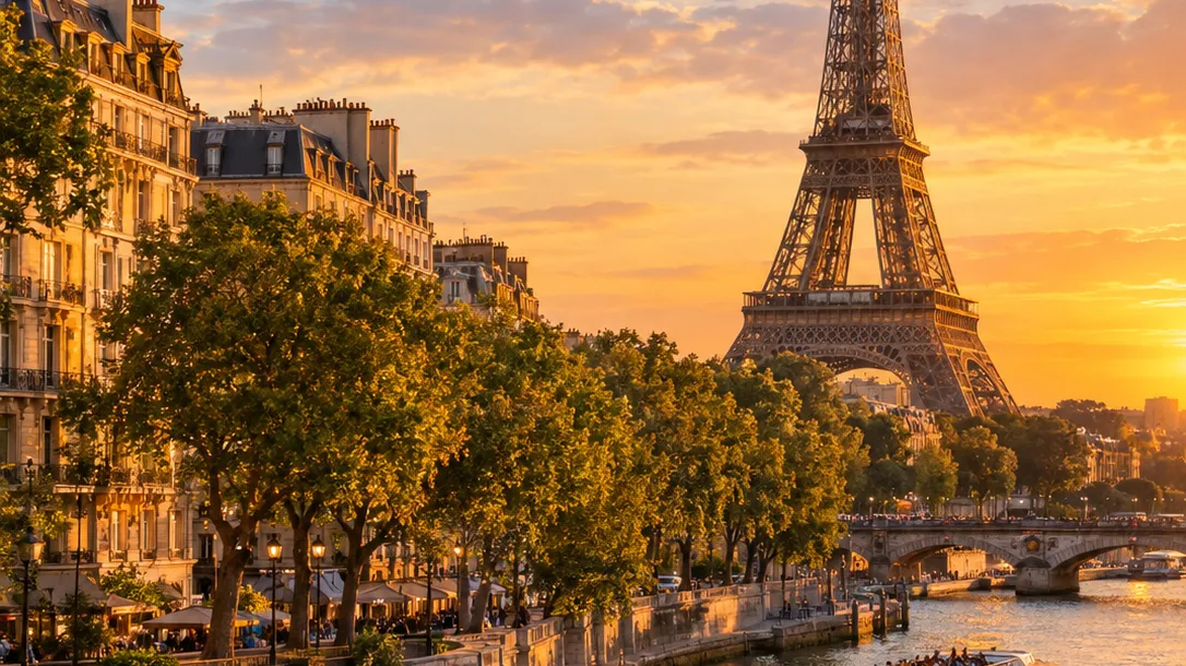 A tree-lined Seine quay with cafes at sunset, with the Eiffel Tower rising beyond